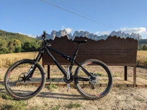 mountain bike in front of bench and mountains