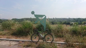 bicycle in front of a cycling sculpture