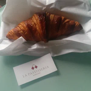Croissant on paperbag with a businesscard from La Pastisseria Barcelona