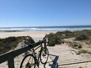 Road bicycle parked at sandy beach