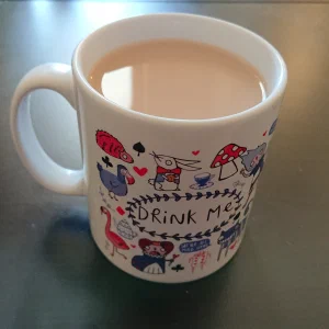 Alice in Wonderland themed tea mug with writing 