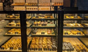 Bakery display with shelves of pastries and croissants