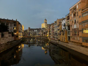 Girona at dusk, with the cathedral and colourful riverside houses reflected in the Onyar