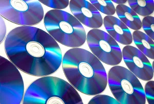Rows of shiny CDs reflecting blue and purple light