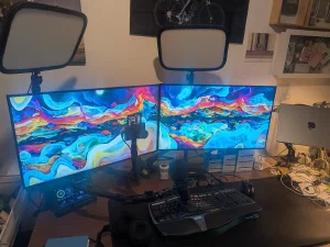 Two monitors on a desk with the XScreenSaver module bubblecolors stretched across both screens